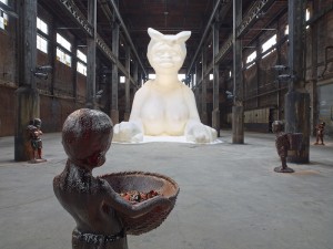 Kara Walker: At the behest of Creative Time Kara E. Walker has confected: A Subtlety, or the Marvelous Sugar Baby, an Homage to the unpaid and overworked Artisans who have refined our Sweet tastes from the cane fields to the Kitchens of the New World on the Occasion of the demolition of the Domino Sugar Refining Plant. A project of Creative Time, installation view: Domino Sugar Refinery, Brooklyn, NY, 2014. Photo: Jason Wyche. Artwork © 2014 Kara Walker.